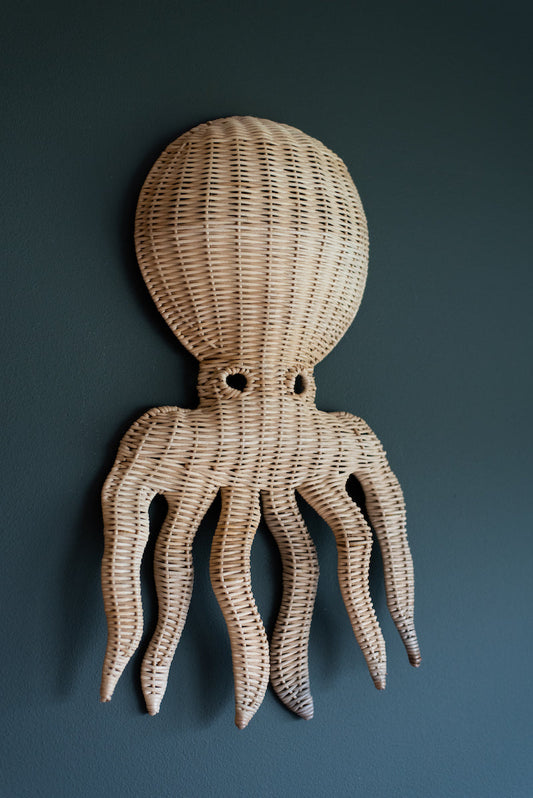 Op de afbeelding is een charmante rotan octopus wanddecoratie te zien, ideaal voor het creëren van een nautische sfeer in elke kamer. Handgemaakt van duurzaam materiaal, biedt dit decoratieve stuk een unieke en organische uitstraling.